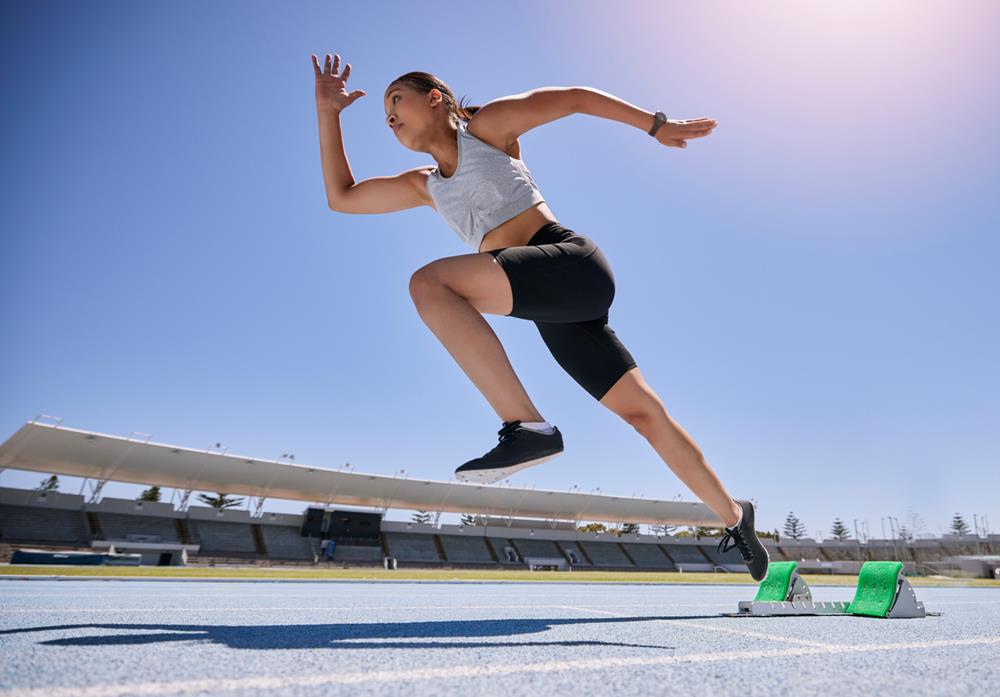 Woman runner running and training on track