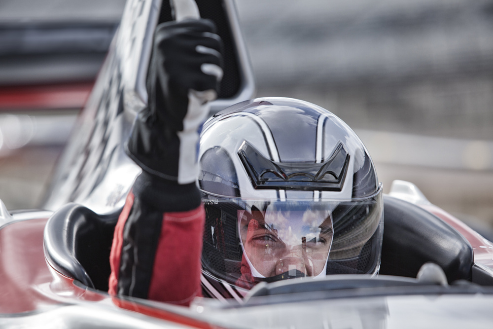 Racer giving thumbs up from car on track
