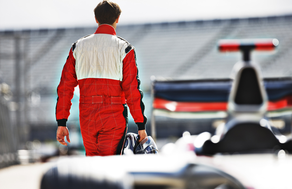 Racer carrying helmet on track